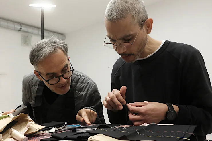 Two men sewing during a Zen sewing workshop